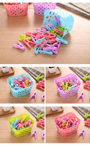 Detail of multi-colored plastic windproof clothes pegs stored in a matching basket