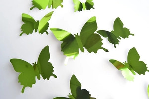 Detailed view of 3D green mirror butterfly wall stickers with reflective metallic finish