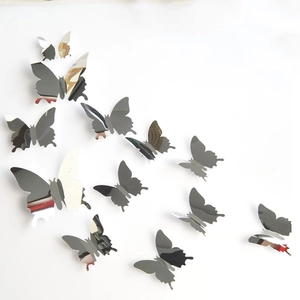Detail view of 12 silver mirror butterfly wall stickers in various sizes for home decor