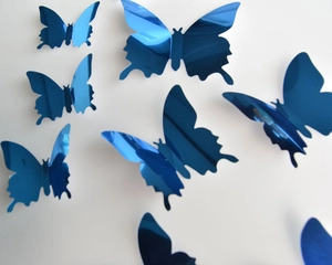 Close-up of blue mirror 3D butterfly wall stickers with reflective surface for decor