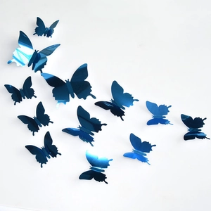 Close-up of blue mirror 3D butterfly wall stickers in various sizes with a glossy finish