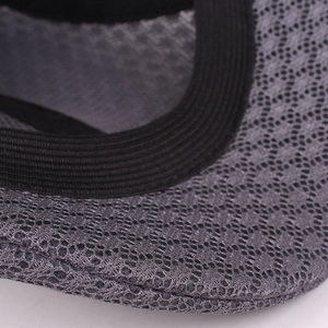 Close-up of gray mesh fabric and black elastic webbing on a vintage flat cap visor