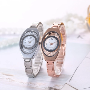 Close-up of elegant women's quartz watches with crystals in silver and rose gold metal