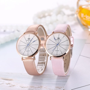 Close-up of elegant women's quartz watches with rose gold cases and leather straps