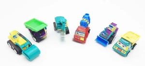 Set of 6 colorful cartoon construction toy trucks with friendly expressions and vivid colors
