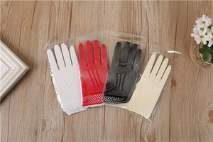 Detailed flat lay of elastic bridal fishnet gloves in white, red, black and beige