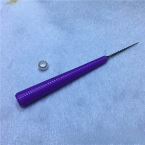 Detail view of manual pearl reamer tool with purple handle and diamond coated needle tip