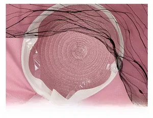 Detail of pink straw sun hat showing interior sweatband and adjustable transparent strap