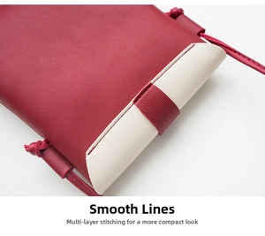 Detail of red and white leather crossbody bag with lychee texture and precision stitching