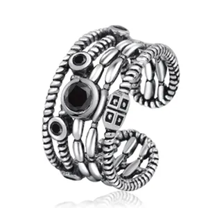 Macro shot of retro layered silver ring with three black gemstones and rope texture