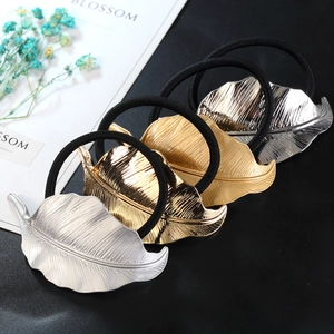 Gold and silver alloy leaf hair ties with irregular patterns and black elastic bands