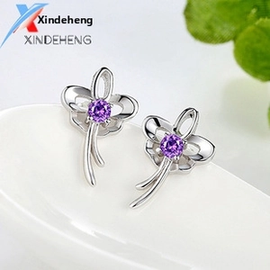 Macro shot of S925 sterling silver tree of life stud earrings with purple amethyst stones
