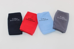 Detail view of breathable cotton baby kneepads in navy, red, light blue, and grey colors