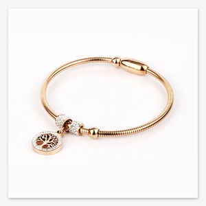 Detail of rose gold tree of life bracelet with crystal bezel and sleek snake chain