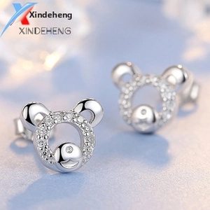 Detailed macro shot of S925 sterling silver bear stud earrings with white cubic zirconia