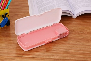 Detail view of pink student pencil case featuring built-in sharpener and dual compartments