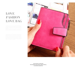 Macro shot of rose red crocodile pattern leather wallet with premium metal zipper detail