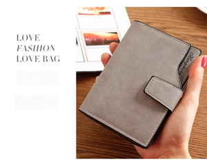 Detail of light grey matte wallet with white stitching and metal snap button closure