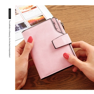 Detail of pink short wallet showing soft matte PU leather texture and metal side zipper