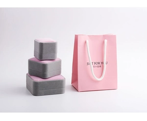 Pink gift bag with JUST FOR YOU text and three grey velvet jewelry display boxes