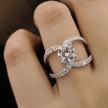 Macro shot of double-C logo ring with large round-cut centerpiece diamond and pavé crystals