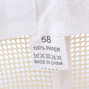 Internal label of a beige mesh jazz hat showing 100% paper material and size 58