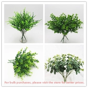 Detailed view of four artificial eucalyptus and money leaf styles in glass vases