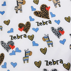 Close-up of zebra and heart patterns on white silk scarf fabric for women