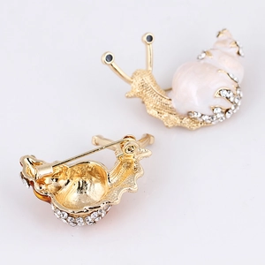 Charming snail-shaped golden brooch with pink faux shell and sparkling rhinestones