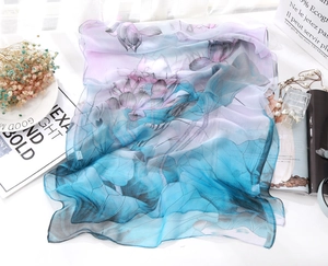 Close-up of lightweight summer scarf with artistic lotus print and sheer texture