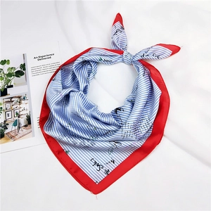 Detail of red-bordered blue and white striped silk scarf with handwritten text