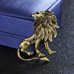 Macro shot of vintage lion brooch featuring leaf mane texture and golden antique finish