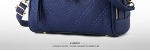Detail of dark blue V-quilted leather handbag with gold metal feet and pebble texture