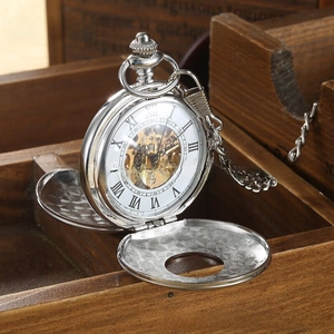 Macro detail of silver mechanical pocket watch with hollow dial and golden movement gears