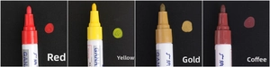 Detailed bullet tips of red, yellow, gold, and brown oil-based paint markers on black