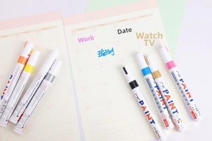 Colorful oil-based paint markers showing vibrant ink coverage on paper journals