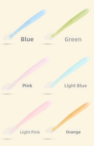 Macro detail of baby silicone feeding spoons with heart patterns in six pastel colors