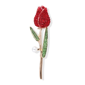 Detailed view of tulip brooch with red crystals, green leaves, and pearl on gold base