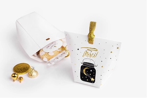 Detail of Christmas candy gift box with gold foil Merci lettering and holiday ribbon