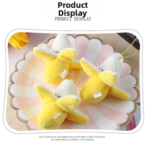 Detail shot of cute peeled banana plush keychains on a decorative pink plate
