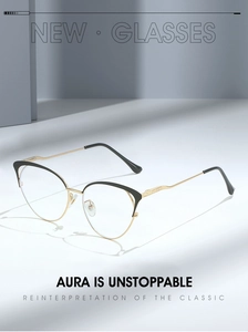 Detail of hollow dual-tone cat-eye glasses frame with fine metal engraving on the temples