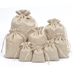 Macro detail of various sizes of natural jute drawstring gift bags with woven texture