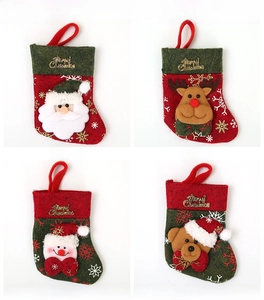 Detail of four Christmas stocking cutlery holders featuring Santa, elk, snowman and bear