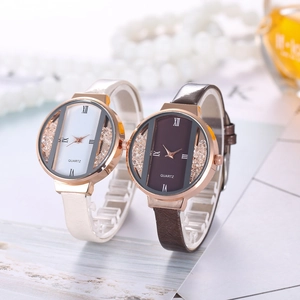 Close-up of rose gold quartz watches with diamond accents and leather straps in two colors