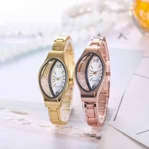 Close-up of asymmetric quartz watch dials with floating diamonds and metal link bands