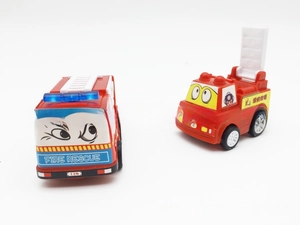 Close-up of red cartoon fire truck toys with movable ladders and rescue decals