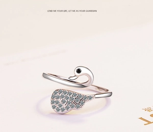 Macro shot of silver swan open ring with black gem and pavé cubic zirconia details