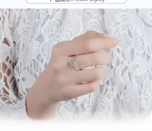 Detailed close-up of peacock ring with sparkling zircon stones worn on hand