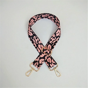 Detail of adjustable pink and black leopard print bag strap with gold metal hardware