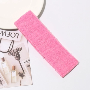 Close-up of pink terry cloth headband with soft texture for yoga and skincare routines